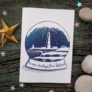 Isle of Portland Christmas Card featuring Portland Bill lighthouse in a snow globe.