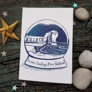 Isle of Portland Christmas Card featuring Pulpit Rock on Portland Bill in a snow globe.